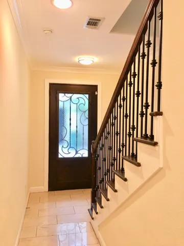 a view of entryway and hall with wooden floor