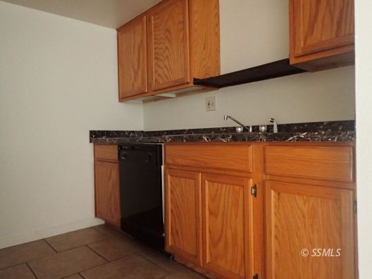 714 North Sanders Street Ridgecrest, CA 93555 - Photo 12 of 15 a view of a storage and utility room with wooden floor