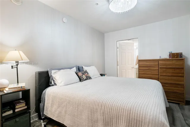 a bedroom with a bed and a lamp