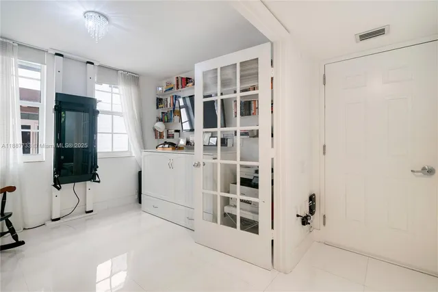 a view of kitchen with refrigerator and window