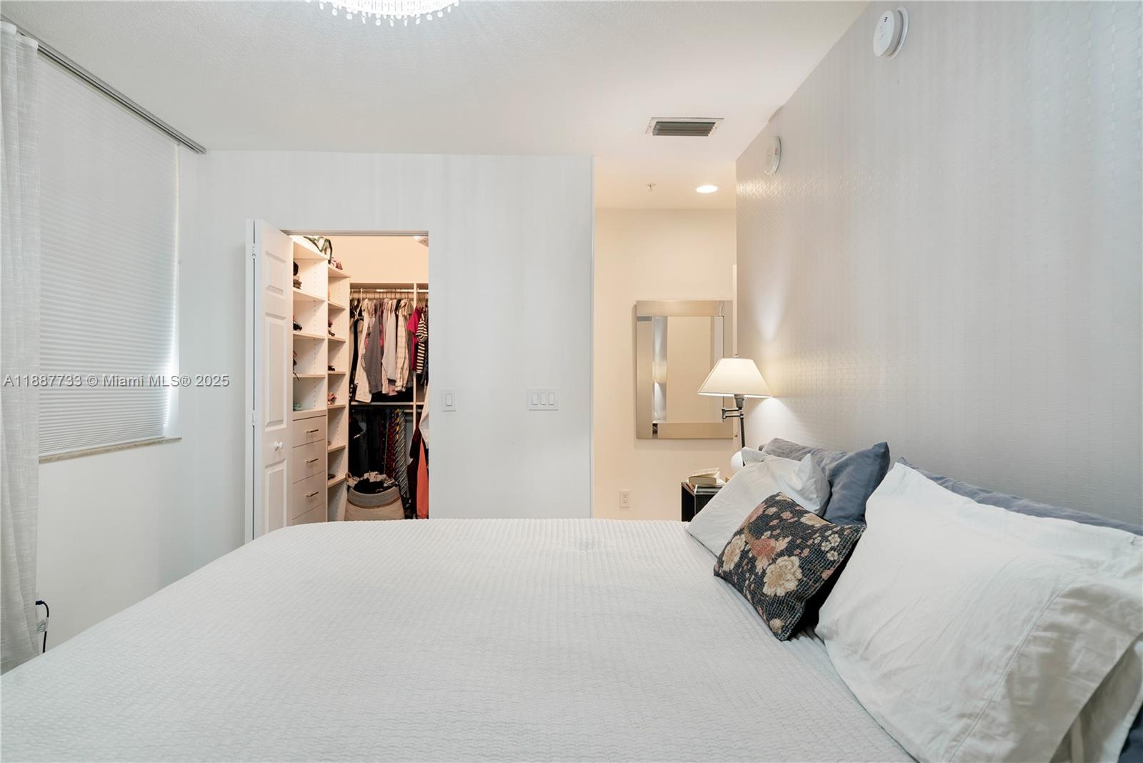 3232 Southwest 22nd Terrace, Unit TH 115 Miami, FL 33145 - Photo 10 of 17 a bedroom with a bed and a lamp