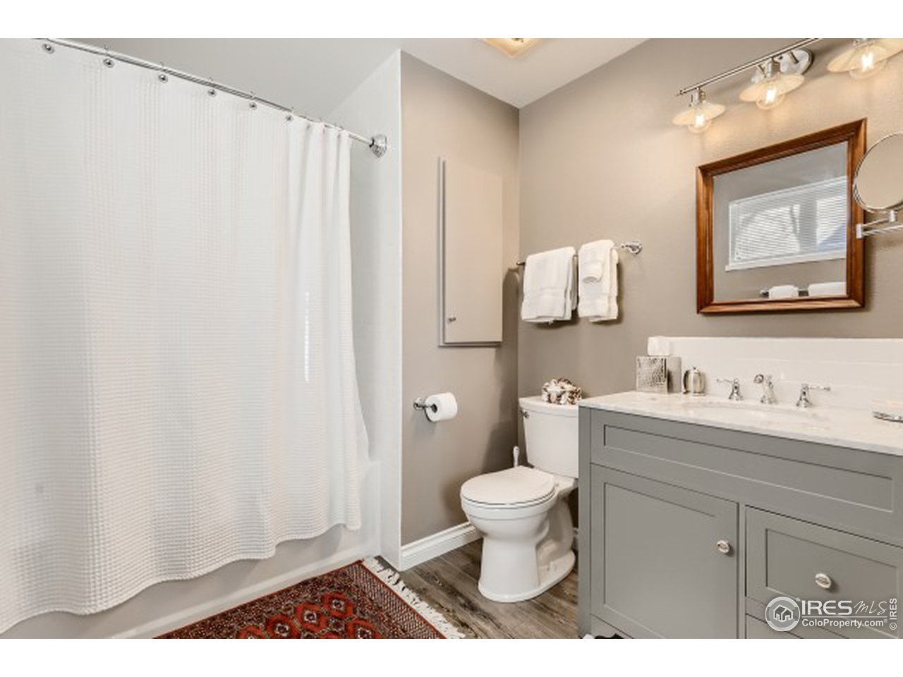 4915 Twin Lakes Road Boulder, CO 80301 - Photo 12 of 15 a bathroom with a toilet a sink and a mirror