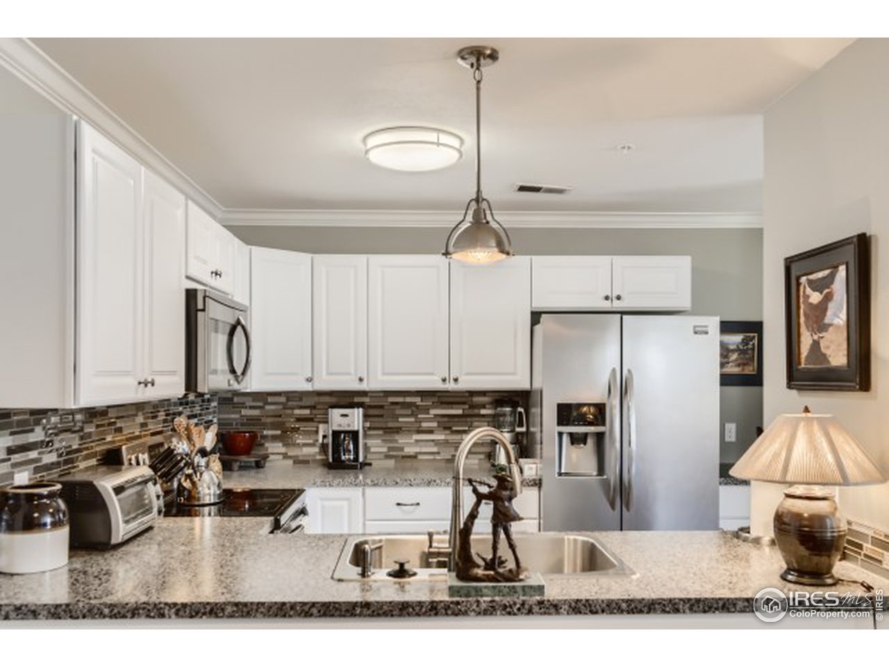 4915 Twin Lakes Road Boulder, CO 80301 - Photo 6 of 15 a kitchen with stainless steel appliances kitchen island granite countertop a refrigerator and a stove top oven