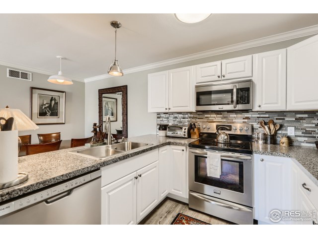 4915 Twin Lakes Road Boulder, CO 80301 - Photo 7 of 15 a kitchen with stainless steel appliances granite countertop a stove a sink and a microwave
