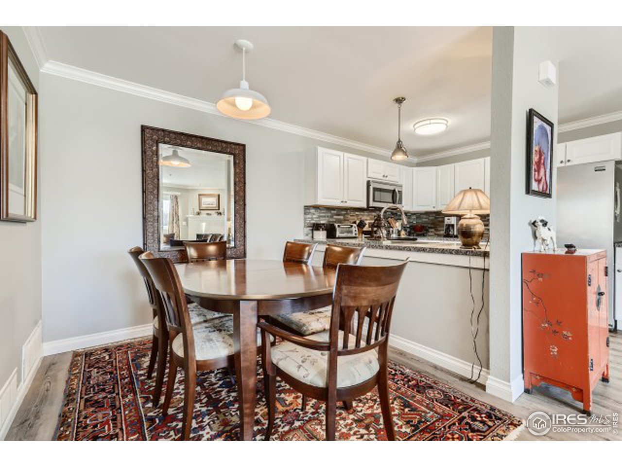 4915 Twin Lakes Road Boulder, CO 80301 - Photo 8 of 15 a kitchen with a dining table chairs and white cabinets