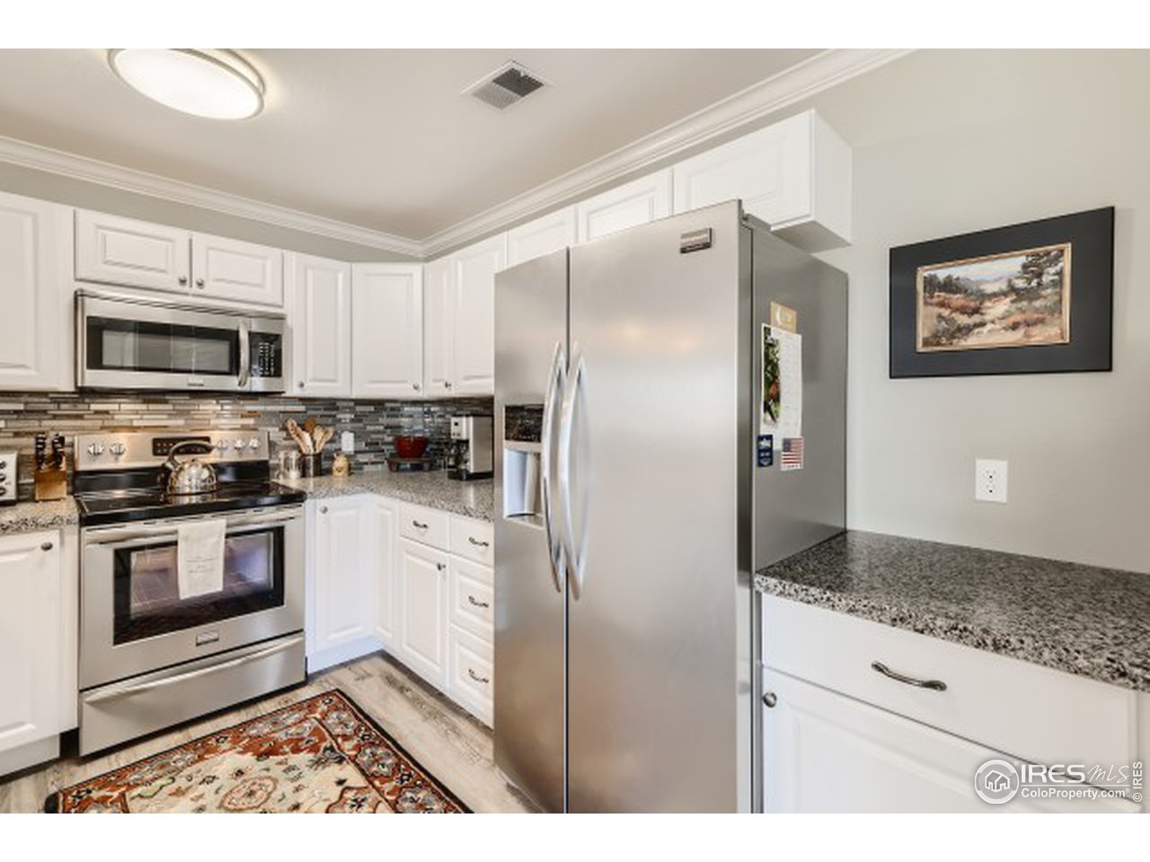 4915 Twin Lakes Road Boulder, CO 80301 - Photo 9 of 15 a kitchen with stainless steel appliances granite countertop a refrigerator a stove a sink and a microwave