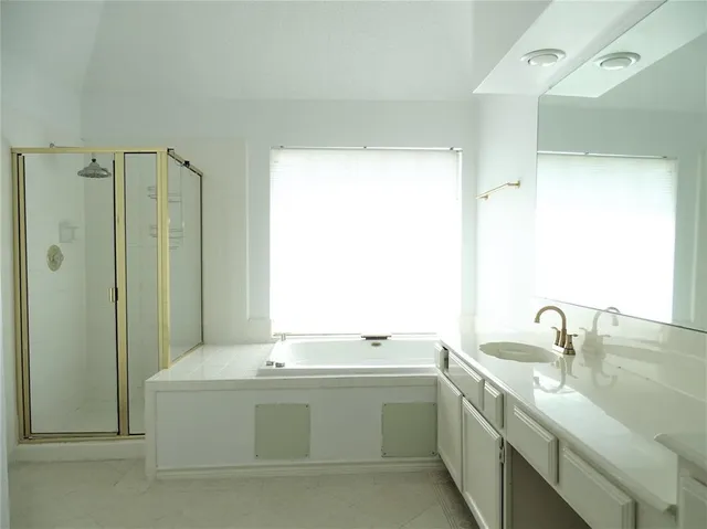 a bathroom with a double vanity sink and mirror