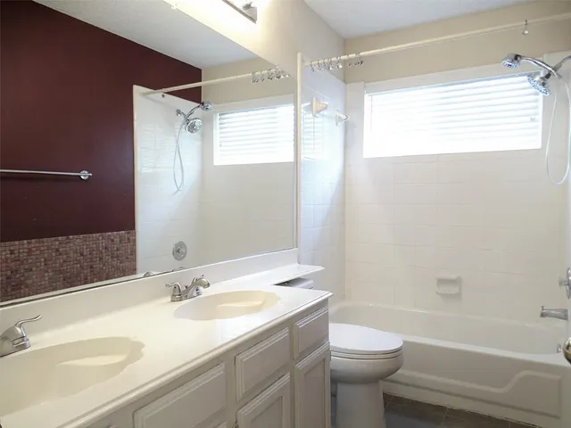 a bathroom with a sink toilet tub and shower