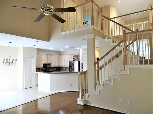 a view of a kitchen with wooden floor and cabinets
