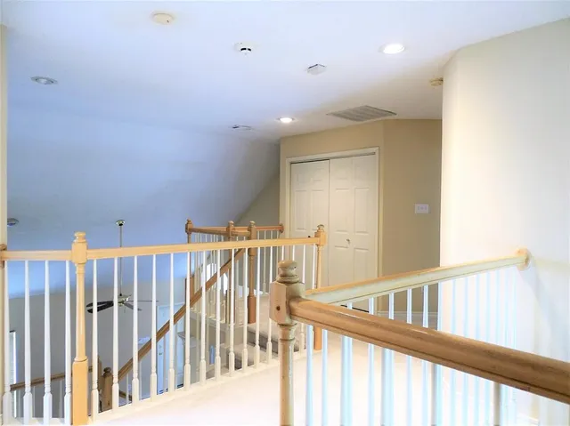 a view of a hallway with a large window and wooden floor