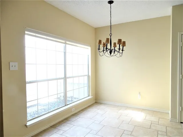 a view of a room with a window and chandelier