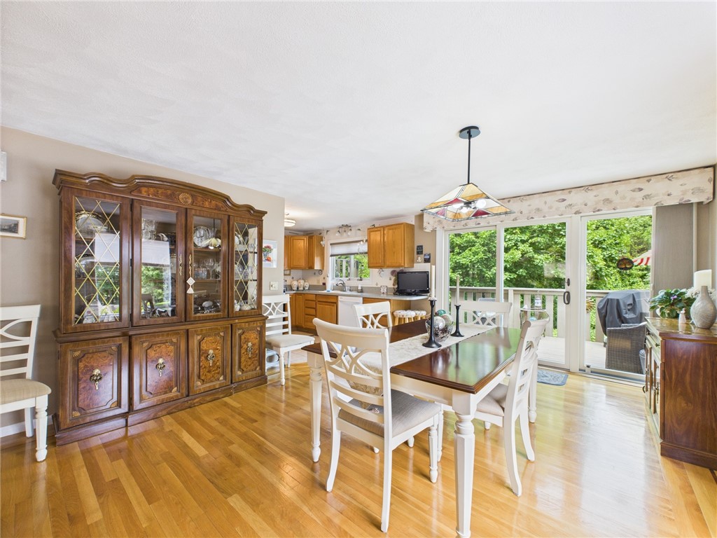 200 Cannon Street, Unit 130 Cranston, RI 02920 - Photo 12 of 26 You can catch a glimpse of the kitchen with its counter seating for 2 in the far left. The triple sliders are NEW! Everything sparkles in this home...and it has a neutral, soothing color scheme in a blend of slightly tinted tones throughout the top 2 floors. The walkout lower suite boasts a more trendy & striking cranberry hue w/white trim!