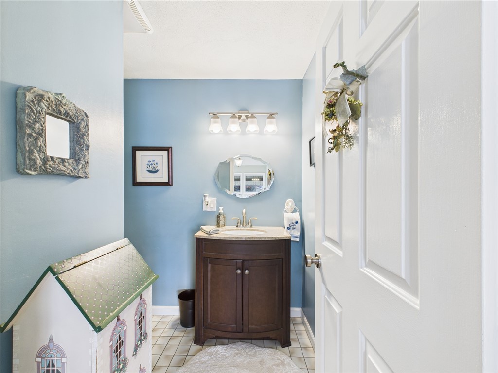 200 Cannon Street, Unit 130 Cranston, RI 02920 - Photo 13 of 26 Sweet 1/2 bath Powder Room is on this level near the carpeted stairway descending to the ground level quarters.