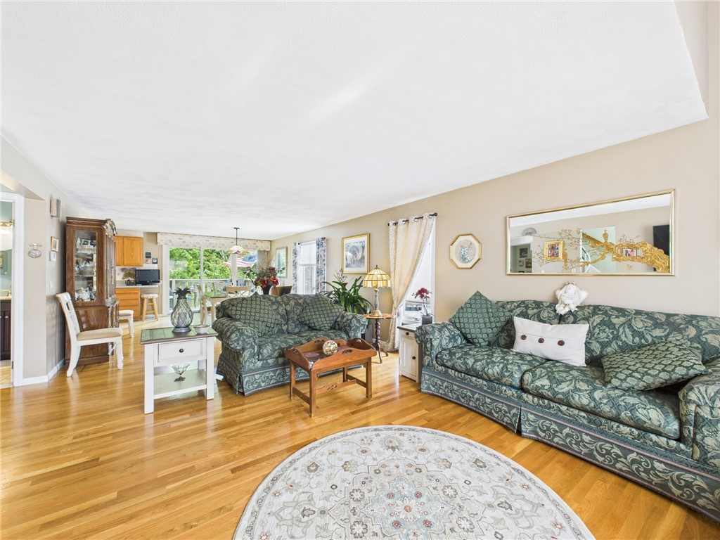 200 Cannon Street, Unit 130 Cranston, RI 02920 - Photo 6 of 26 From the front door entry, one accesses the main level living area and views the span of the beautifully appointed living/dining rooms to the sliders to the deck.