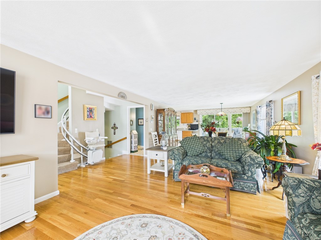 200 Cannon Street, Unit 130 Cranston, RI 02920 - Photo 7 of 26 Taken from the interior of the living room, one sees curved ascending stairs leading to the top floor. Further to the left is the descent to the finished hallway accessing the 3rd BR suite/family room/office...also to the utility room, & heated 1 car garage w/deep sink and walls lined with shelves. There is a 50 gallon HW tank & new motor & purifier on gas heating system. A/C has been updated too! The condenser motor is 2-3 yrs old. Off camera, behind the short wall on left is the entry hall to this floor.
