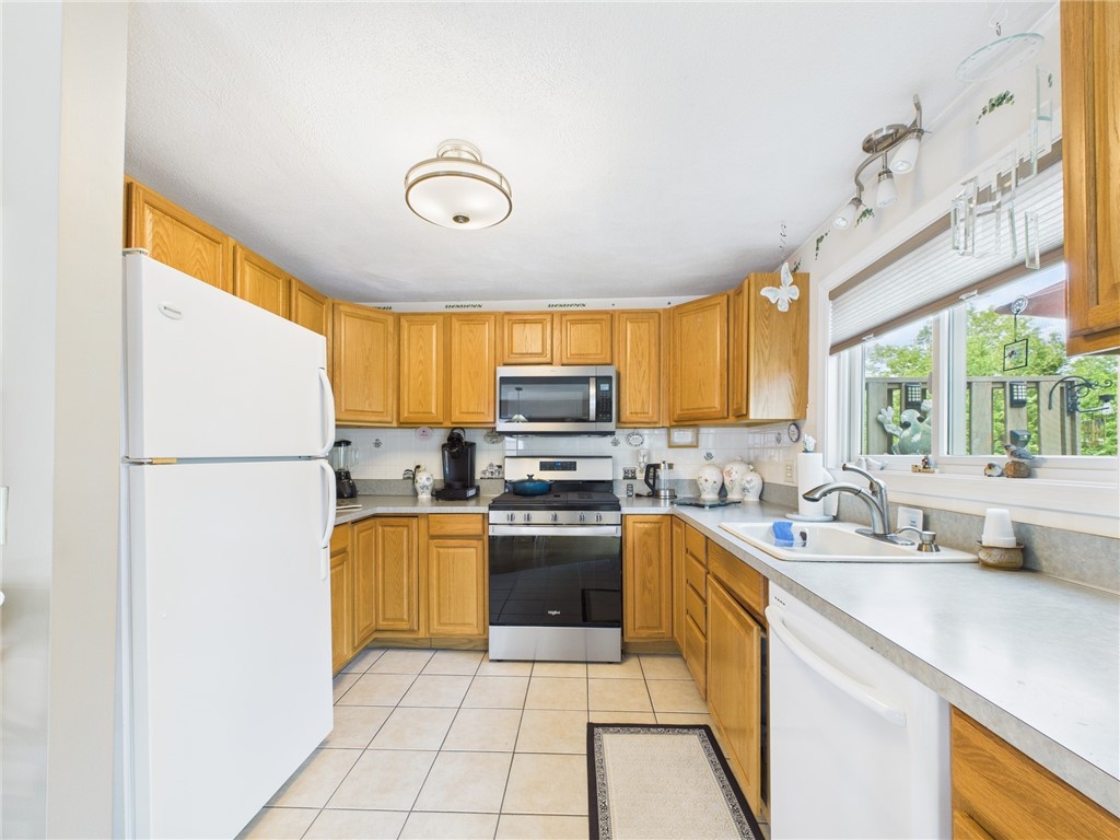 200 Cannon Street, Unit 130 Cranston, RI 02920 - Photo 9 of 26 Sparkling, galley kitchen with new windows without cranks so as not to interfere with those on the deck. The kitchen also offers seating for 2 before the slider, off camera. The stove and micro with fan were purchased in 2024. You'll marvel at the abundance and variety of cupboards ....the chef will be pleased!