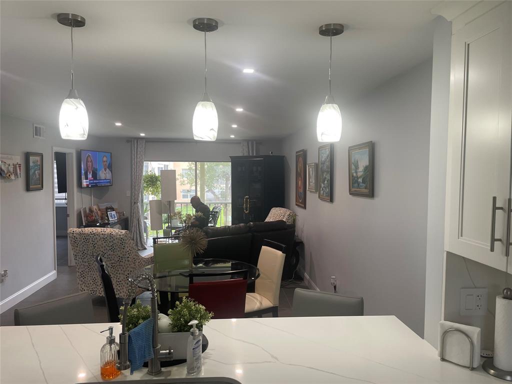 9818 Marina Boulevard, Unit 1220 Boca Raton, FL 33428 - Photo 12 of 18 a living room with furniture and a chandelier