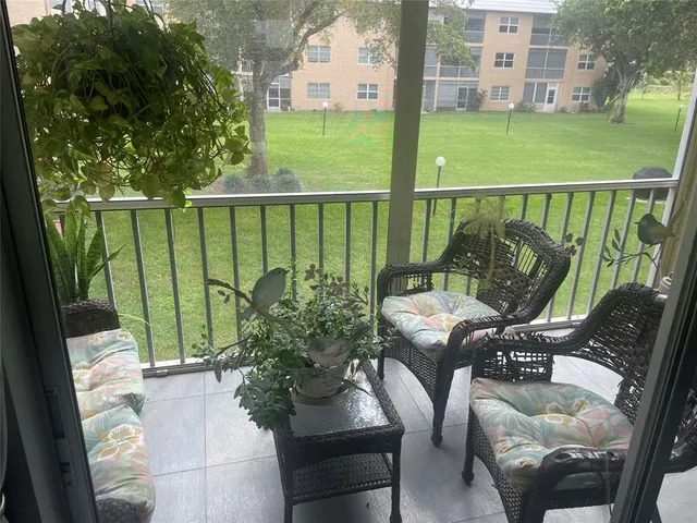 a view of a chairs and table in patio