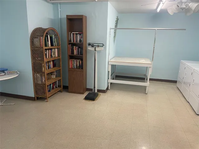a room with a furniture and a book shelf