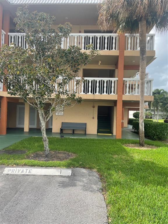 9818 Marina Boulevard, Unit 1220 Boca Raton, FL 33428 - Photo 17 of 18 a front view of house with yard