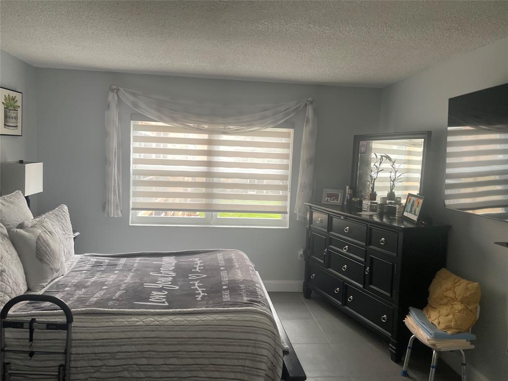 9818 Marina Boulevard, Unit 1220 Boca Raton, FL 33428 - Photo 6 of 18 a bedroom with a bed and window