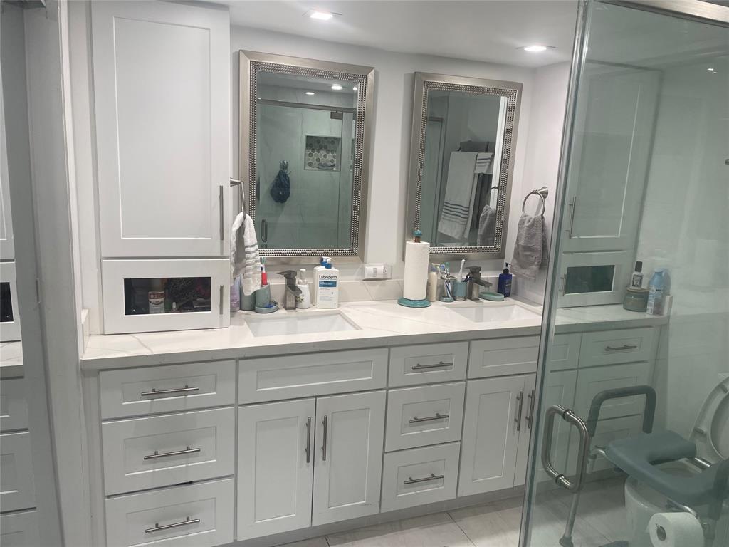 9818 Marina Boulevard, Unit 1220 Boca Raton, FL 33428 - Photo 8 of 18 a bathroom with a sink and a mirror