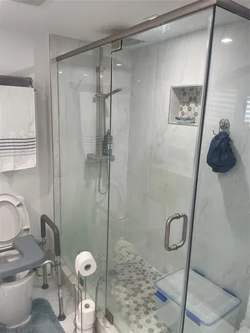 a bathroom with a toilet and a shower