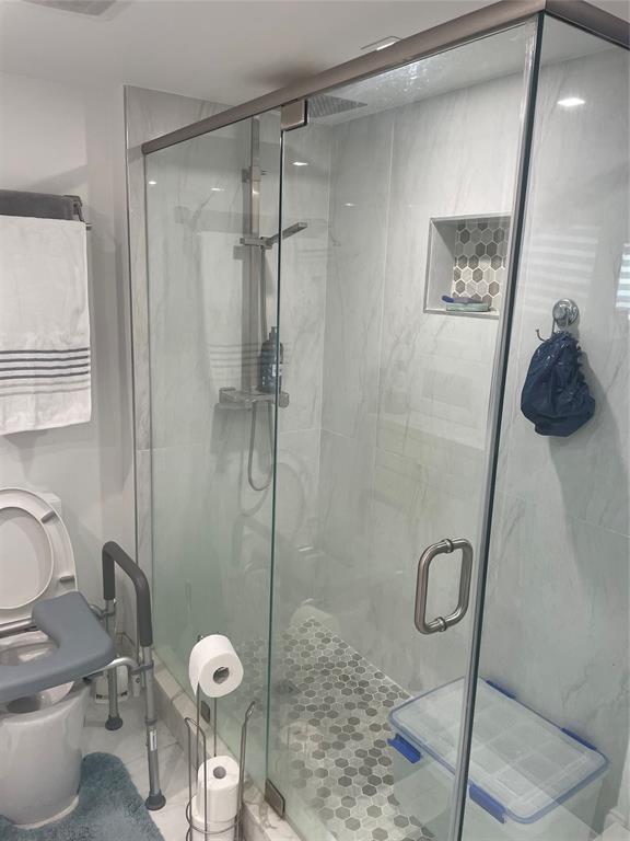 9818 Marina Boulevard, Unit 1220 Boca Raton, FL 33428 - Photo 9 of 18 a bathroom with a toilet and a shower