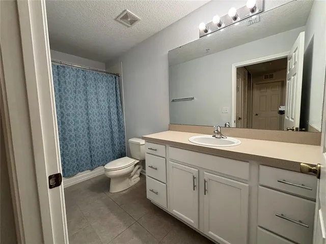 a bathroom with a double vanity sink toilet and shower