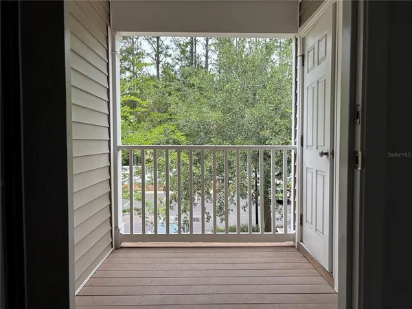a view of a room with wooden floor and a window