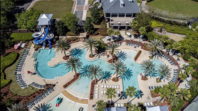 an aerial view of a house with a garden and swimming pool