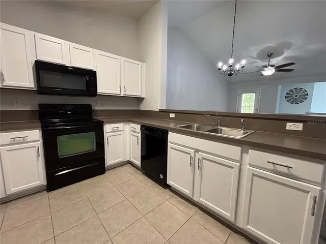 a kitchen with a sink stove and microwave