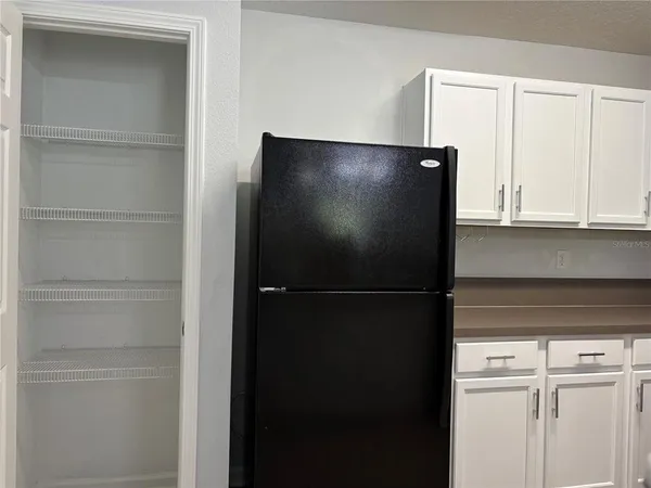 a view of a refrigerator in kitchen with a refrigerator