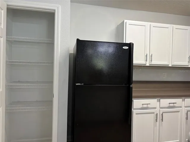 a view of a refrigerator in kitchen with a refrigerator