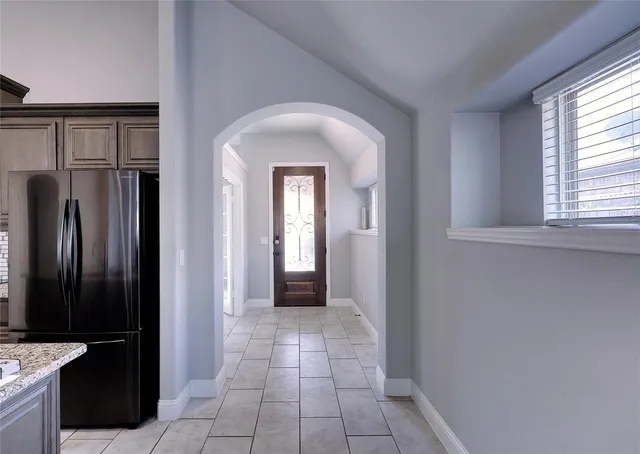 a view of a hallway with wooden floor and a cabinet