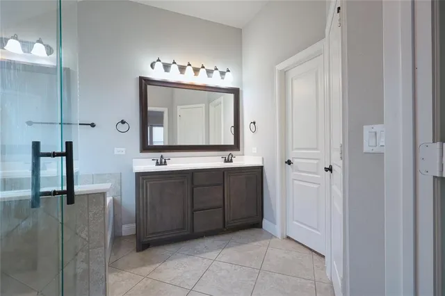 a bathroom with a sink vanity and mirror