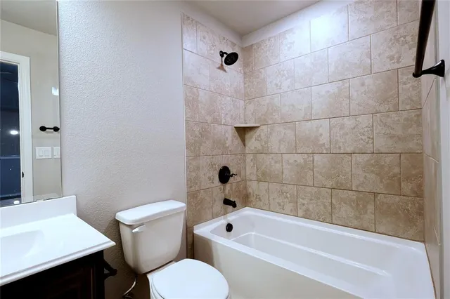 a bathroom with a toilet a sink and bathtub