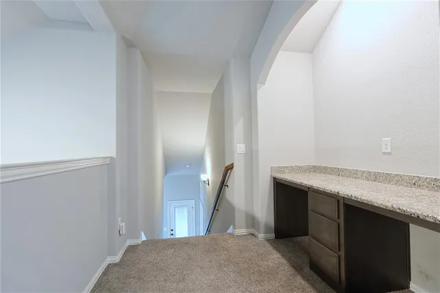 a view of a kitchen from the hallway