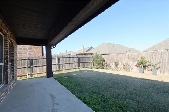 a view of a porch with a big yard and large tree
