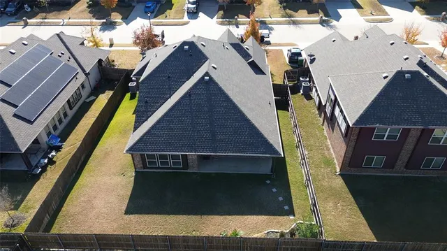 an aerial view of residential houses with outdoor space