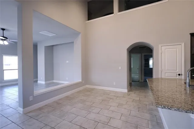a view of a hallway with wooden shelves