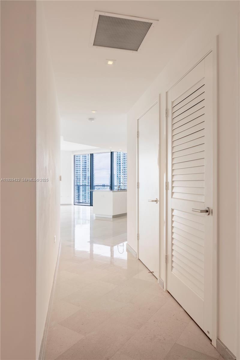 68 Southeast 6th Street, Unit 2112 Miami, FL 33131 - Photo 2 of 20 a view of empty room with wooden floor