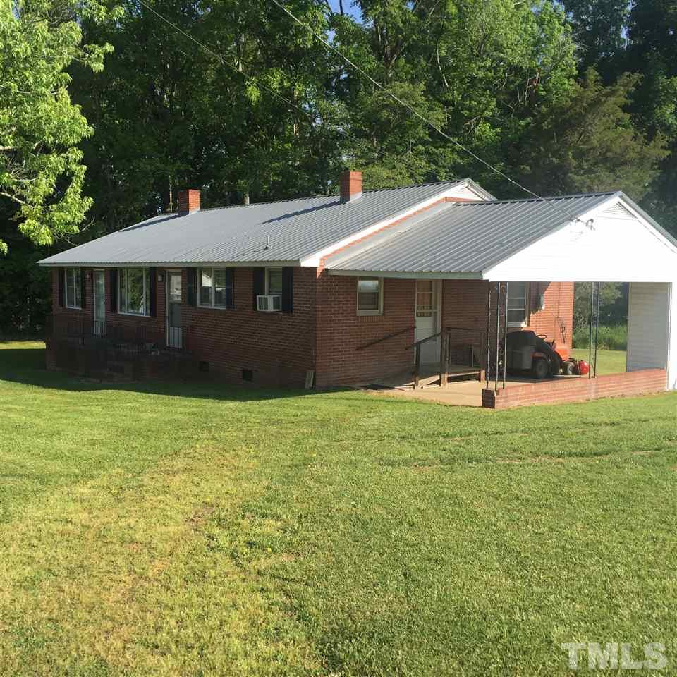 4845 Oxford Road Roxboro, NC 27574 - Photo 1 of 6 a view of a house with backyard and a garden