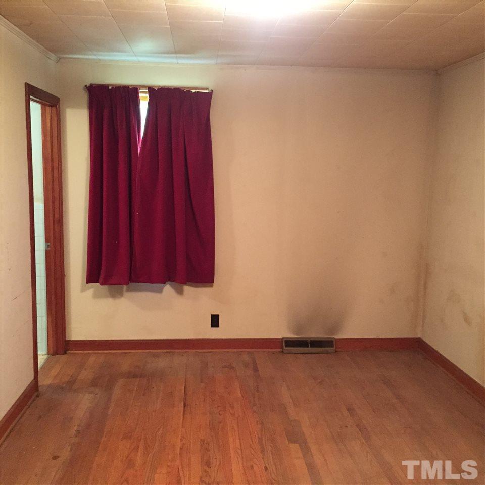 4845 Oxford Road Roxboro, NC 27574 - Photo 4 of 6 a view of a room with wooden floor and windows