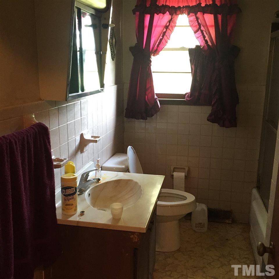 4845 Oxford Road Roxboro, NC 27574 - Photo 5 of 6 a bathroom with a toilet sink and mirror