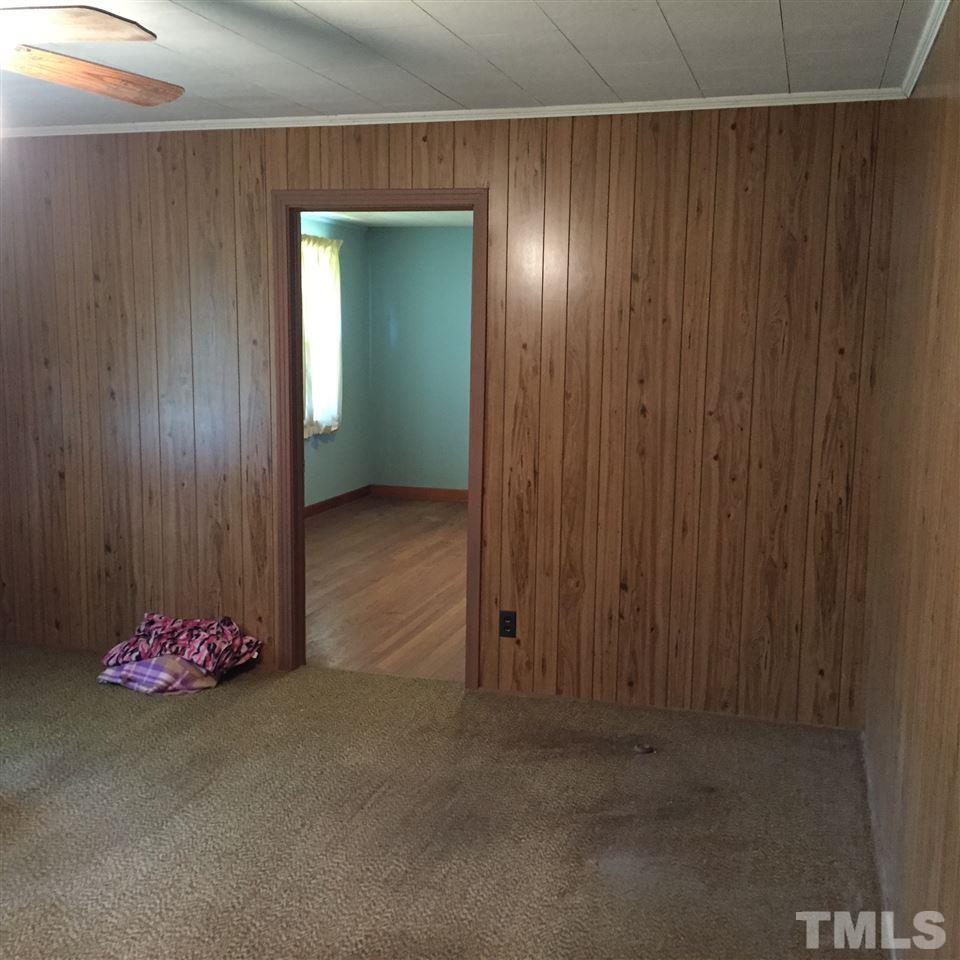 4845 Oxford Road Roxboro, NC 27574 - Photo 6 of 6 an empty room with a door