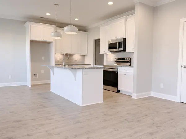 a kitchen with stainless steel appliances granite countertop a stove top oven a sink dishwasher and a refrigerator with wooden floor