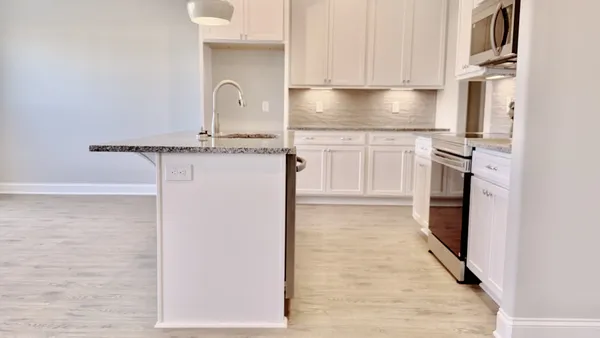 a kitchen with a refrigerator sink and cabinets