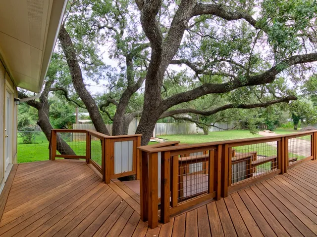 a view of house with deck outdoor seating and covered with wooden floor