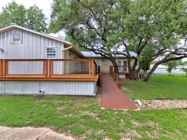 a view of a hallway with wooden floor and entryway
